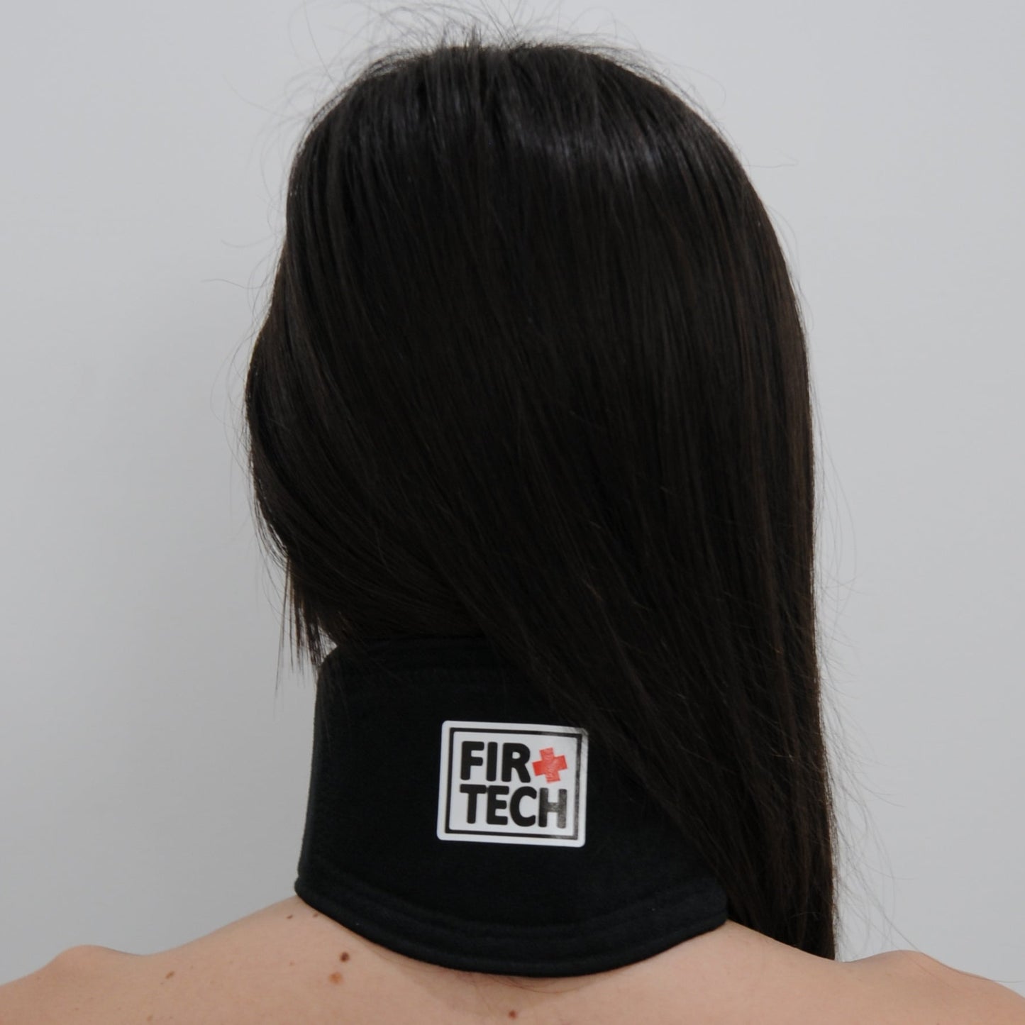 Person wearing a black headband with 'Fire Tech' logo on a white background